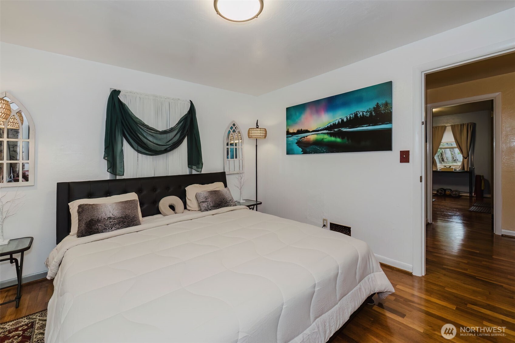 3126 Rocky Point Road Northwest Bremerton, WA 98312 - Photo 19 of 40 a bedroom with a bed and a painting on the wall