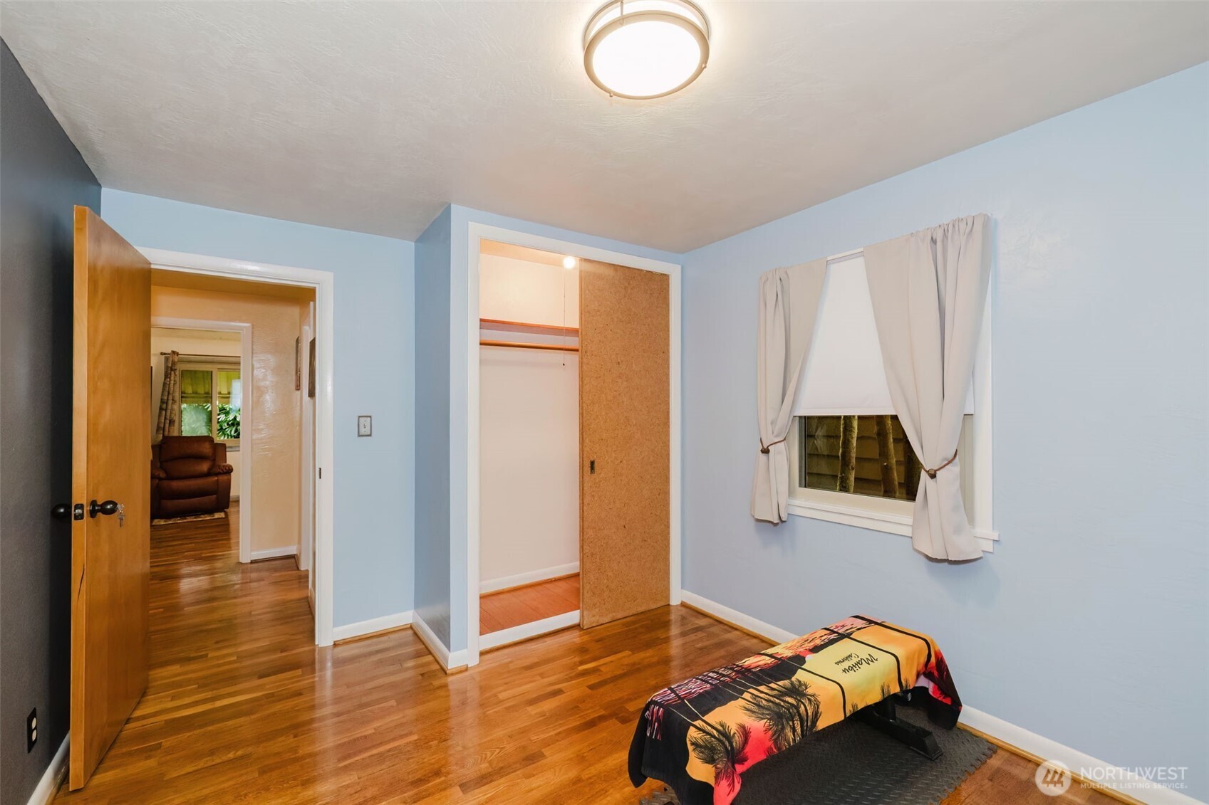 3126 Rocky Point Road Northwest Bremerton, WA 98312 - Photo 24 of 40 a bedroom with a bed and wooden floor