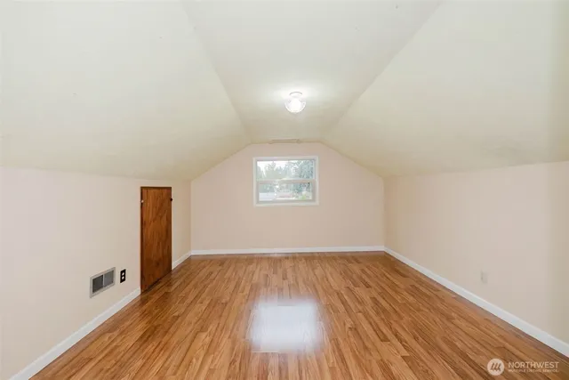 a view of hallway with wooden floor