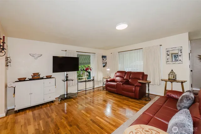 a living room with furniture window and wooden floor