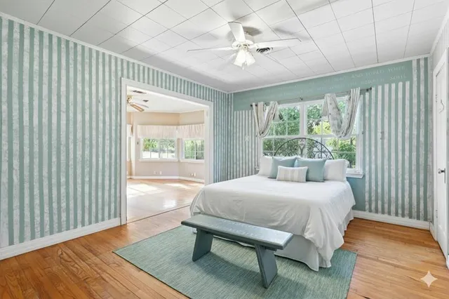 a bedroom with a bed and a window