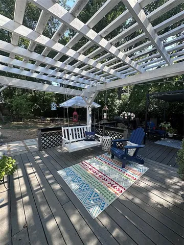 a view of a patio with table and chairs a barbeque with wooden floor