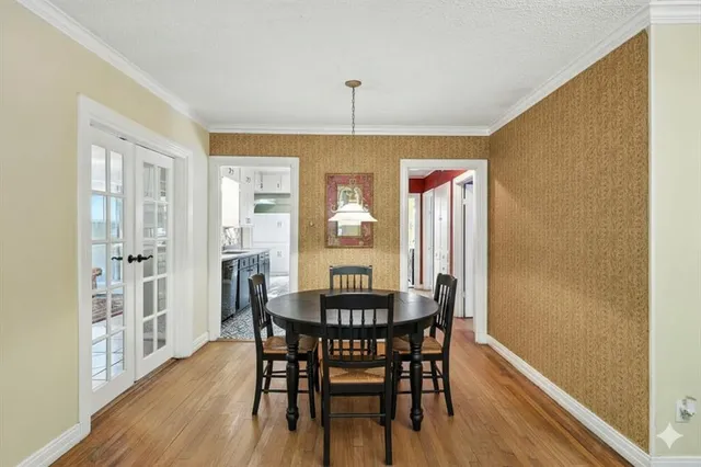 a dining room with furniture window and wooden floor