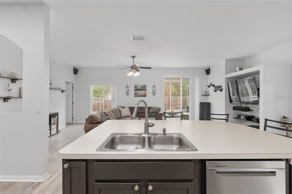 224 Oak Lane Ocala, FL 34472 - Photo 11 of 33 a kitchen with a sink a counter and chairs