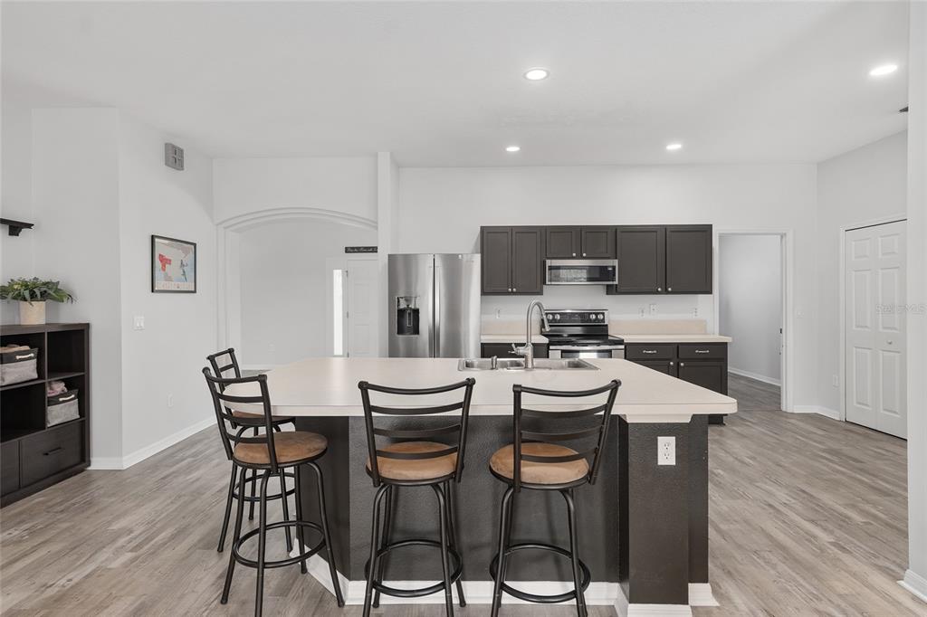 224 Oak Lane Ocala, FL 34472 - Photo 12 of 33 a kitchen with stainless steel appliances kitchen island granite countertop a sink and wooden cabinets