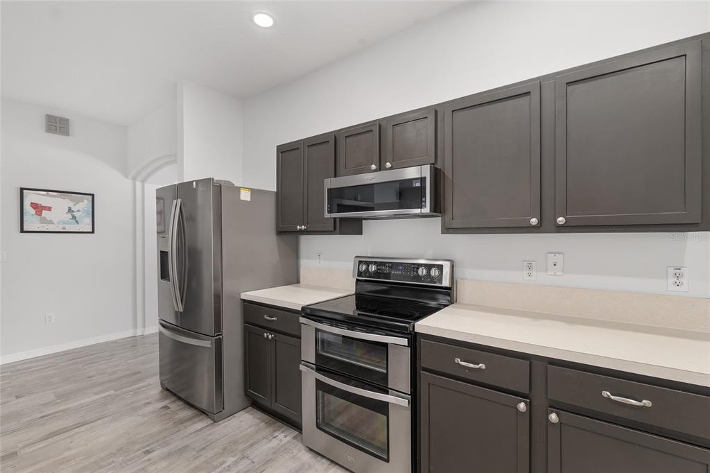 224 Oak Lane Ocala, FL 34472 - Photo 14 of 33 a kitchen with stainless steel appliances a refrigerator stove and microwave
