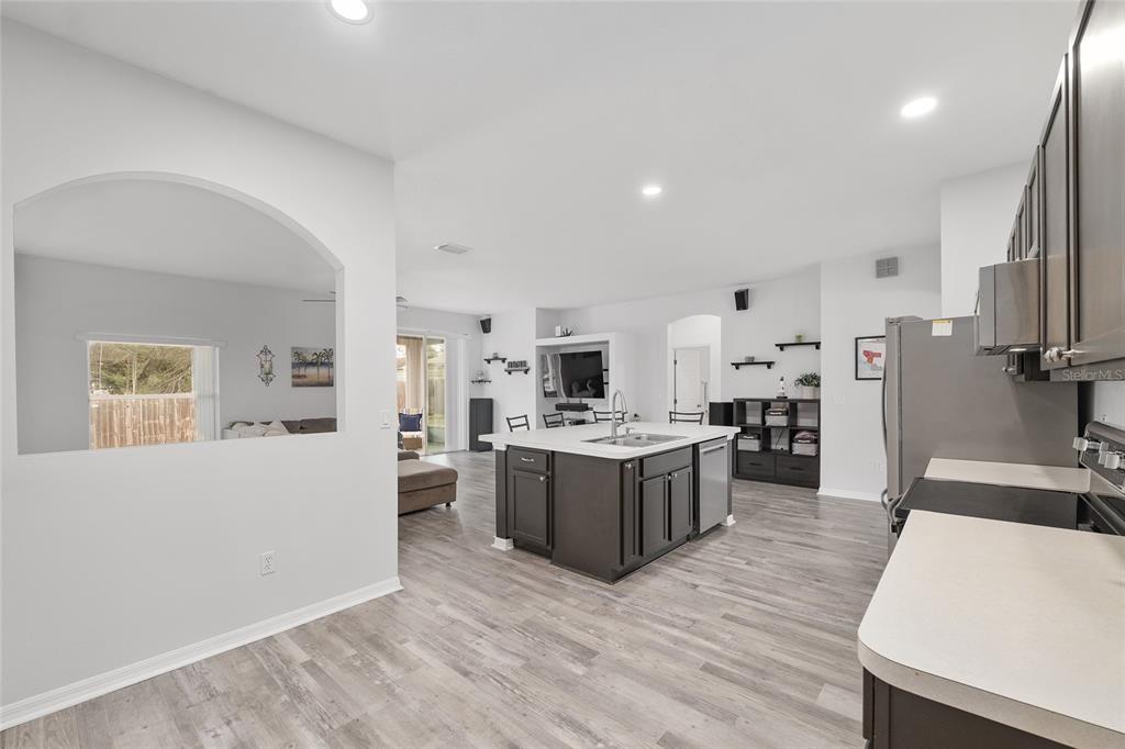 224 Oak Lane Ocala, FL 34472 - Photo 16 of 33 a large kitchen with a table and chairs in it