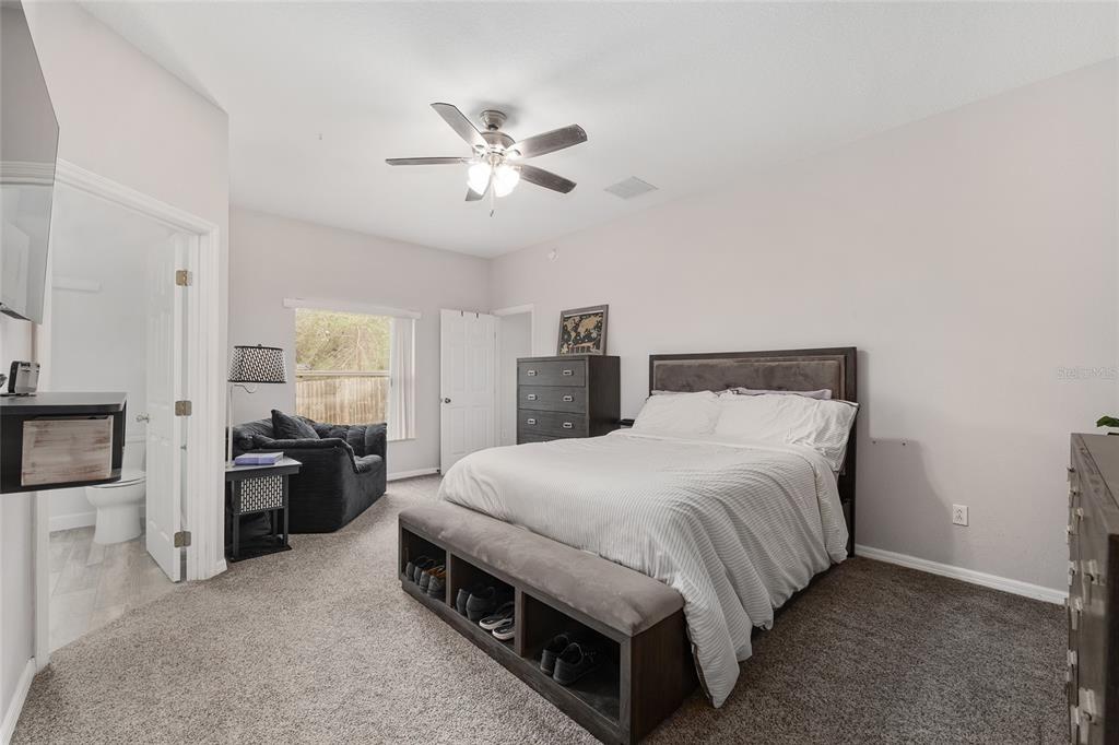 224 Oak Lane Ocala, FL 34472 - Photo 17 of 33 a bedroom with a bed and a chandelier