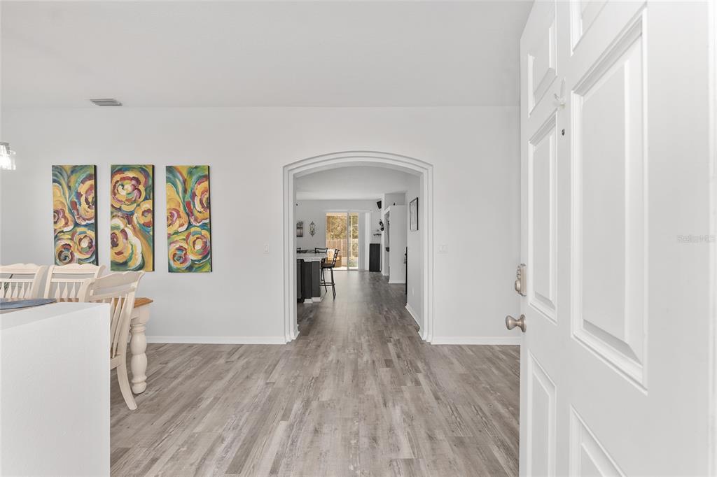 224 Oak Lane Ocala, FL 34472 - Photo 4 of 33 a view of a hallway with wooden floor and closet