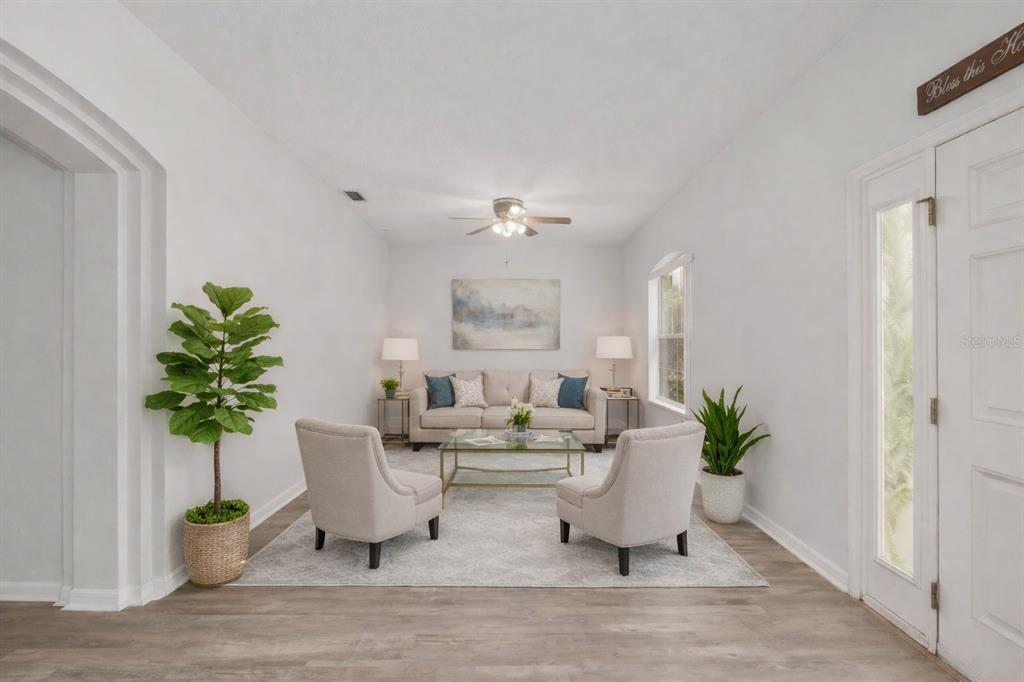 224 Oak Lane Ocala, FL 34472 - Photo 7 of 33 a living room with furniture and a potted plant
