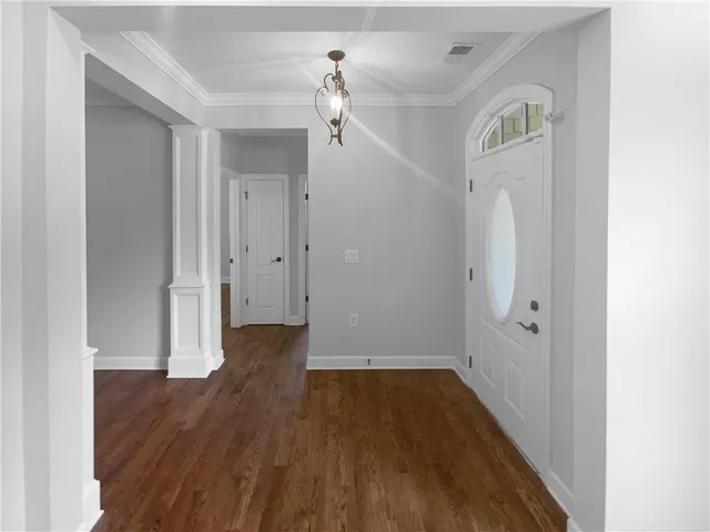 a view of a hallway with wooden floor