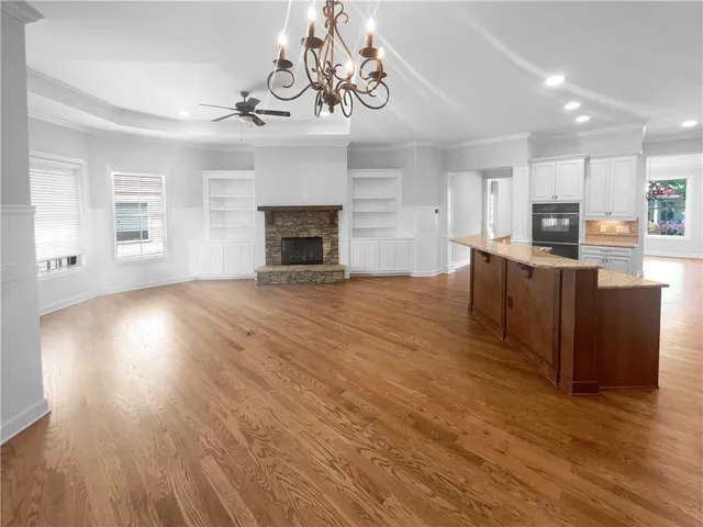 a view of a kitchen with furniture wooden floor and window