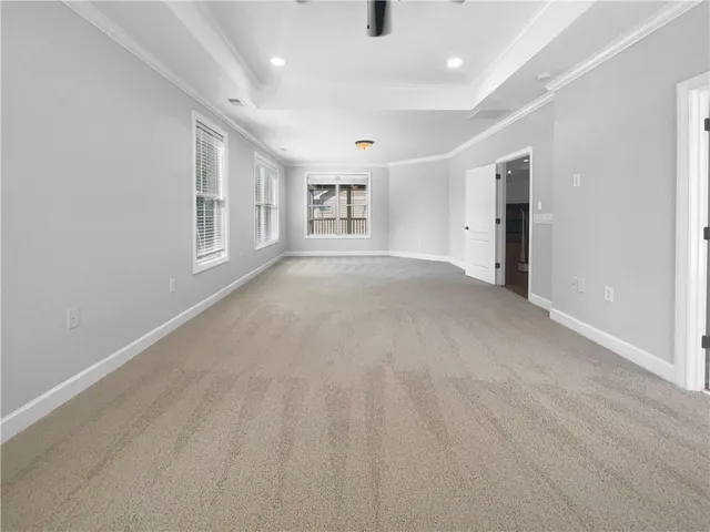 an empty room with windows and cabinet