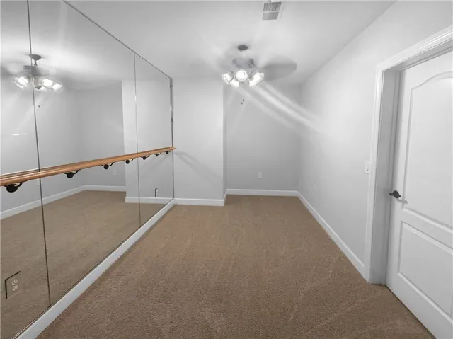 wooden floor in an empty room with a mirror