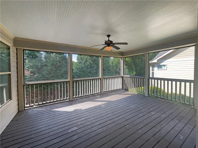 a view of a room with wooden floor and windows