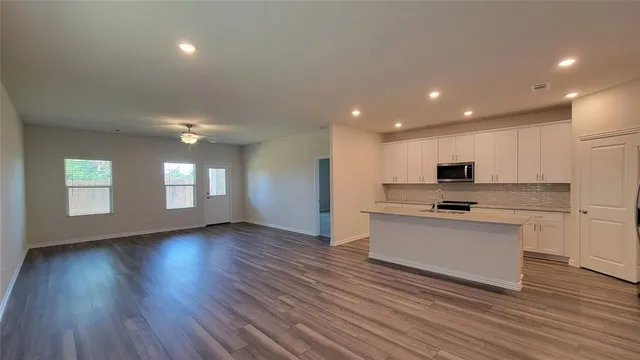 a view of kitchen with sink microwave and stove