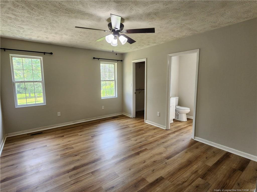 5444 Rockfish Road Raeford, NC 28376 - Photo 14 of 37 a view of an empty room with a window and wooden floor