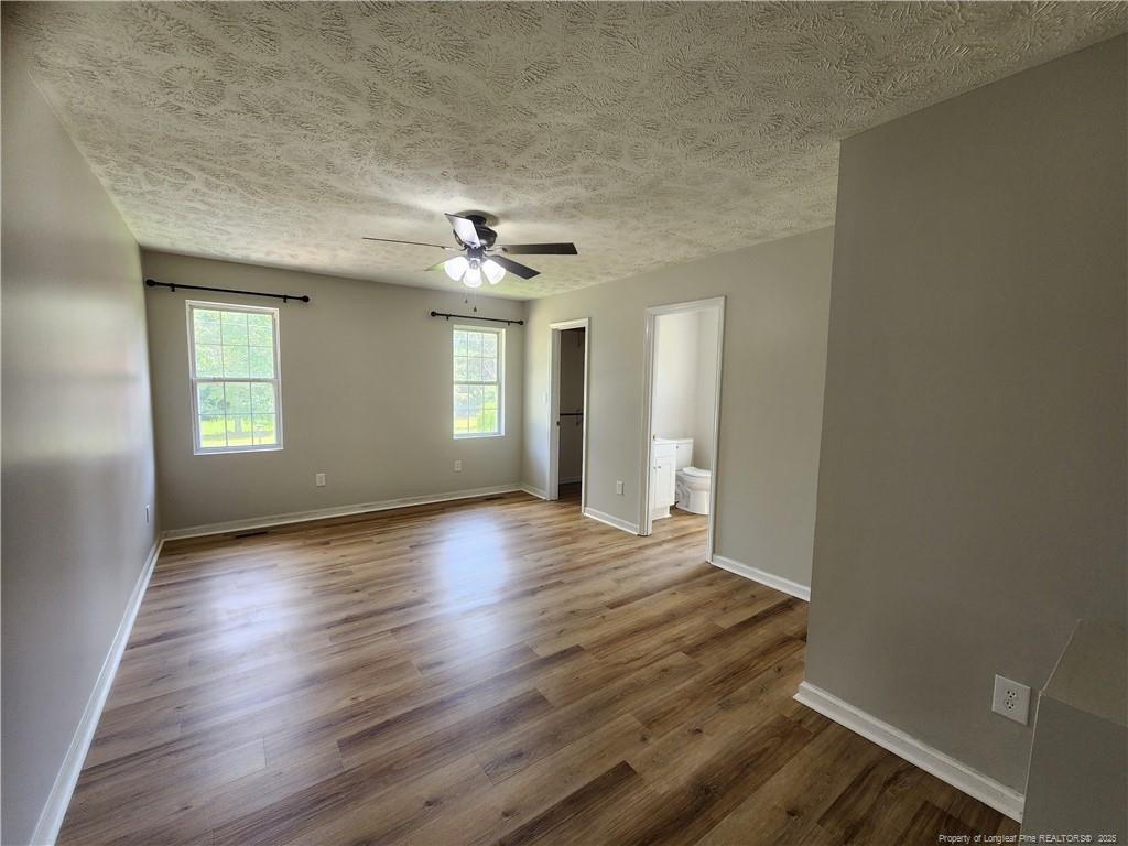 5444 Rockfish Road Raeford, NC 28376 - Photo 16 of 37 an empty room with wooden floor and windows