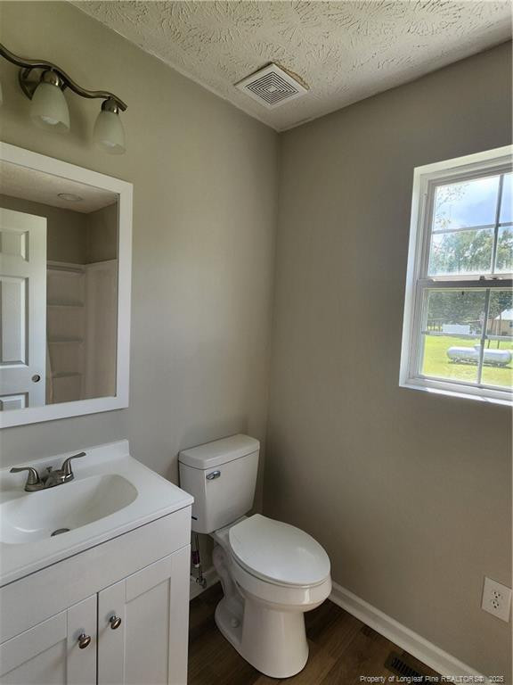 5444 Rockfish Road Raeford, NC 28376 - Photo 19 of 37 a bathroom with a toilet sink and mirror