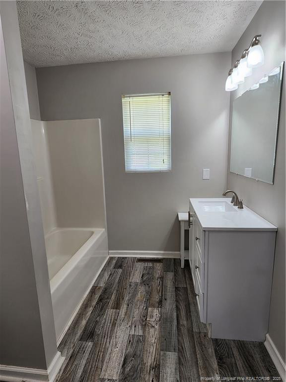 5444 Rockfish Road Raeford, NC 28376 - Photo 22 of 37 a bathroom with a sink a mirror and a bathtub