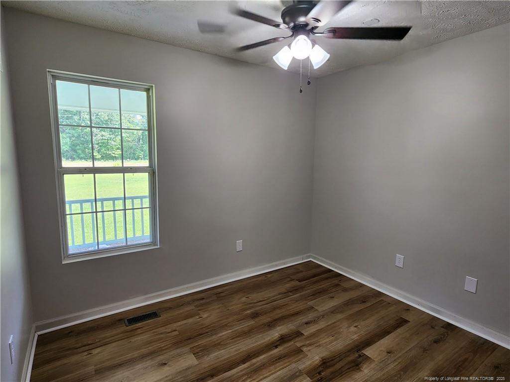 5444 Rockfish Road Raeford, NC 28376 - Photo 28 of 37 wooden floor in an empty room with a window