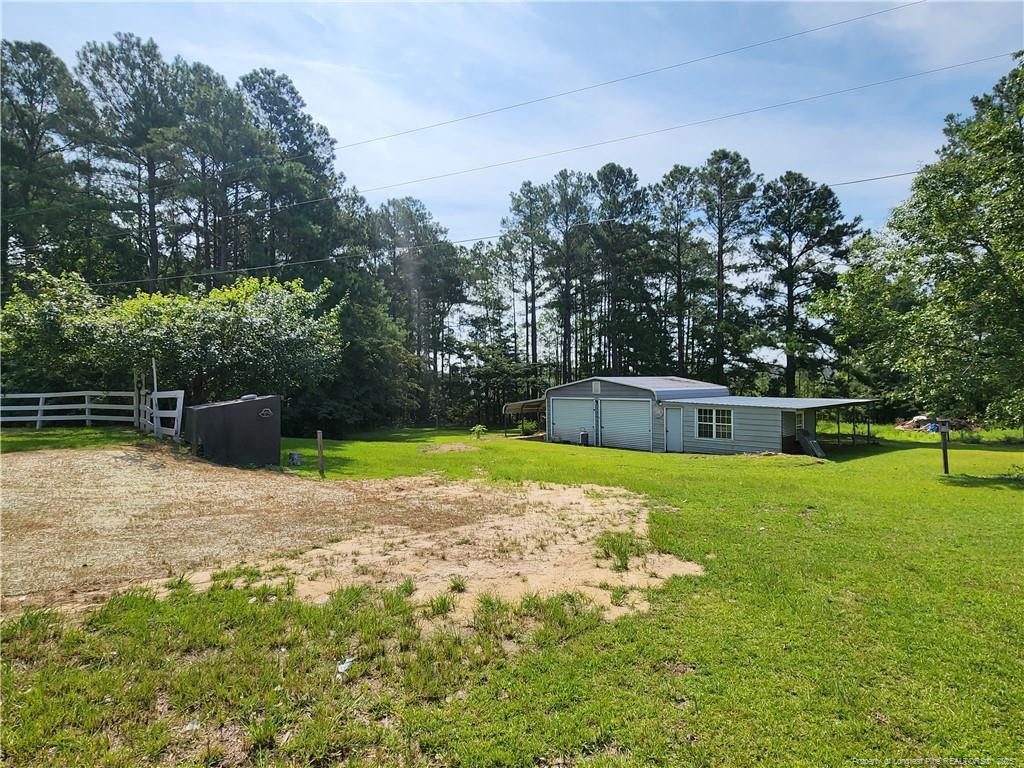 5444 Rockfish Road Raeford, NC 28376 - Photo 37 of 37 a backyard of a house with lots of green space
