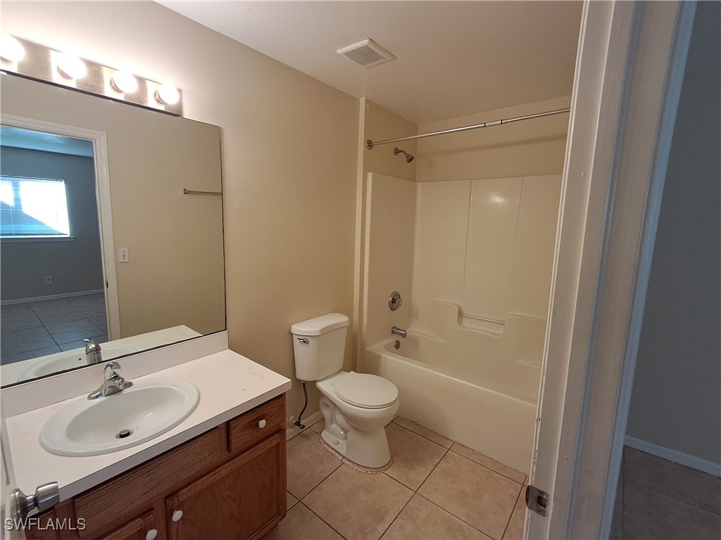 133 Meadow Road Lehigh Acres, FL 33973 - Photo 12 of 12 a bathroom with a sink toilet and shower