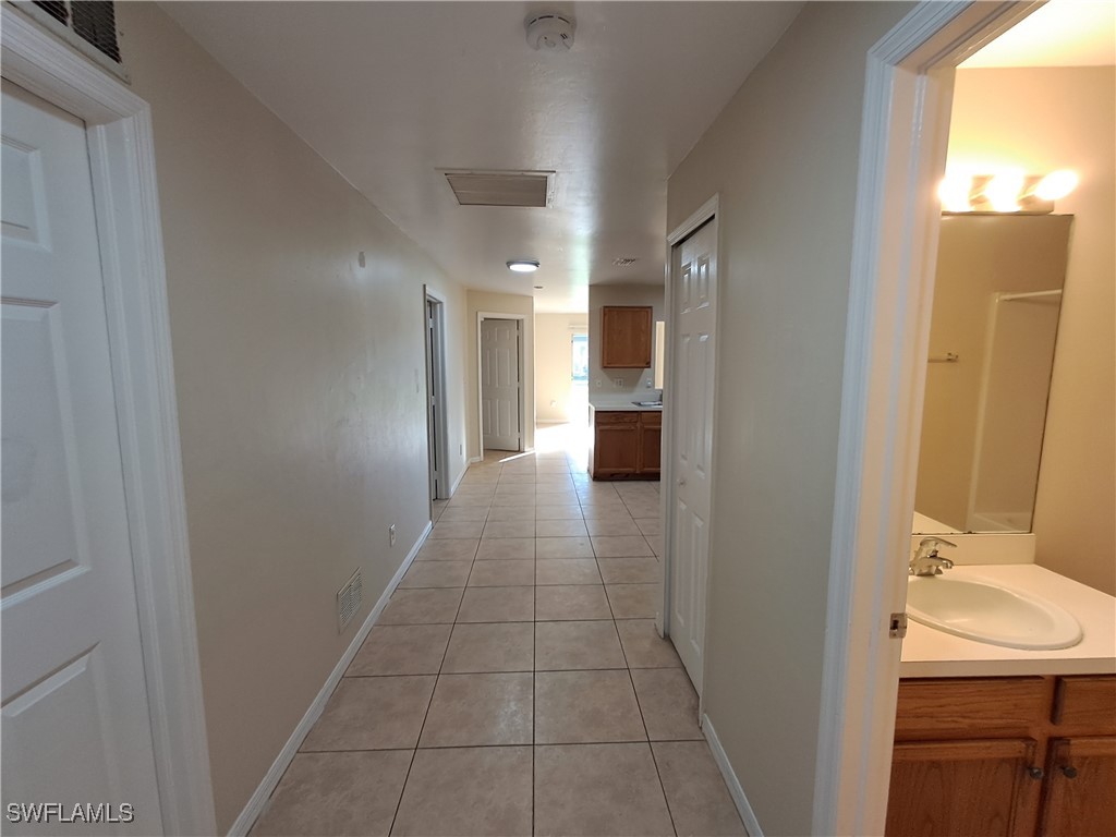 133 Meadow Road Lehigh Acres, FL 33973 - Photo 2 of 12 a bathroom with a sink and mirror