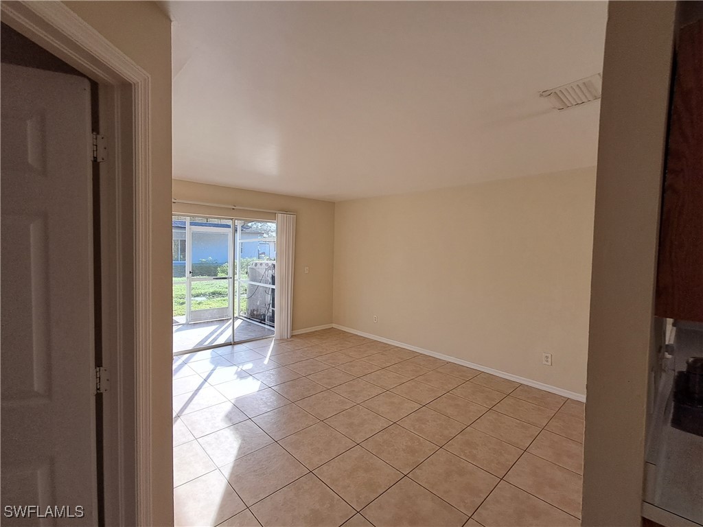 133 Meadow Road Lehigh Acres, FL 33973 - Photo 7 of 12 a view of an empty room and window