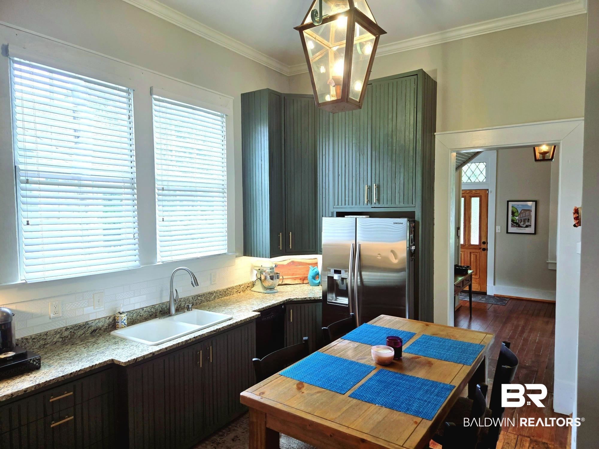 54 South Catherine Street Mobile, AL 36604 - Photo 21 of 55 Kitchen with a sink, stainless steel fridge with ice dispenser, dark wood-type flooring, crown molding, and light stone counters