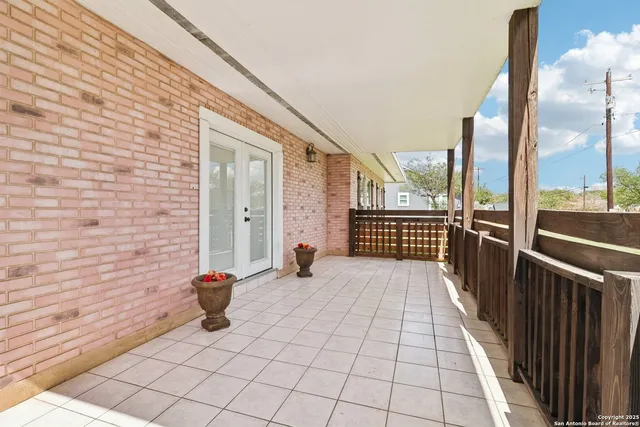 a view of a hallway with wooden floor and a livingroom view