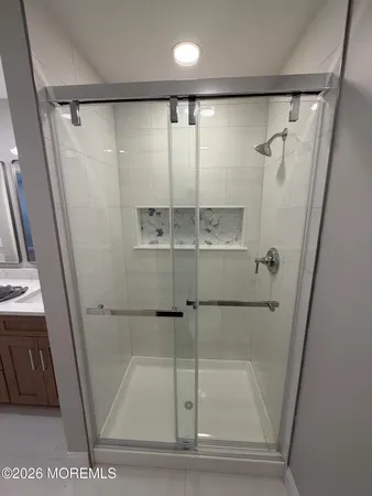 a bathroom with a glass shower door