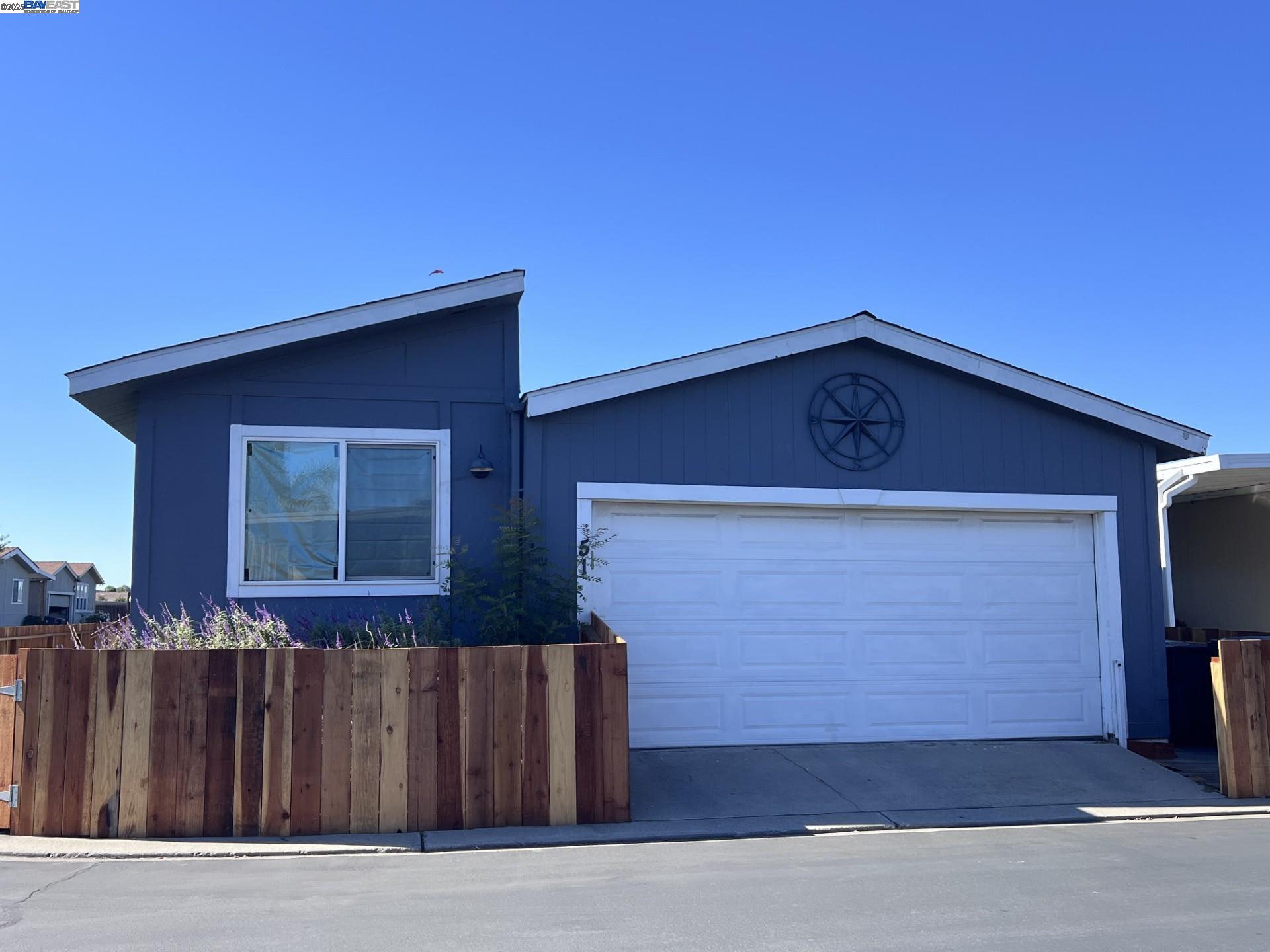 a front view of a house with wooden fence