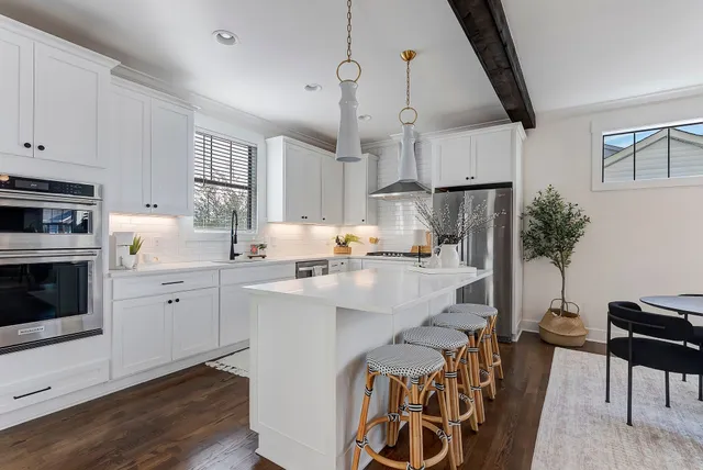a kitchen with white cabinets and stainless steel appliances