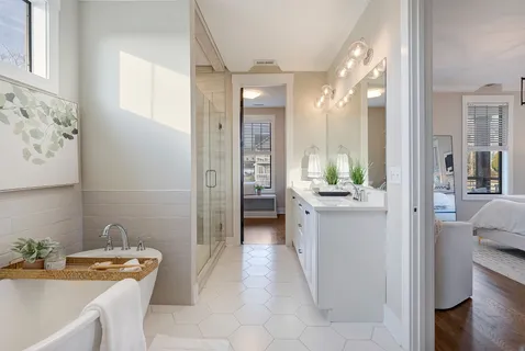 a bathroom with a tub sink and mirror