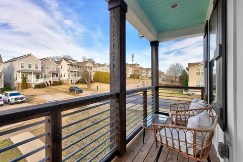 a view of a city from a balcony with furniture