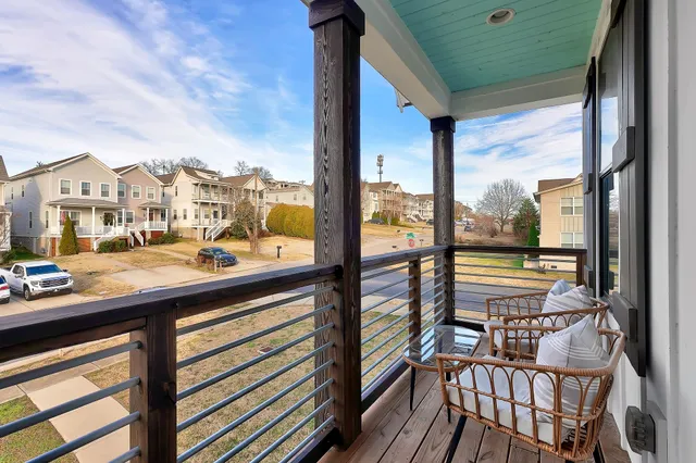 a view of a city from a balcony with furniture