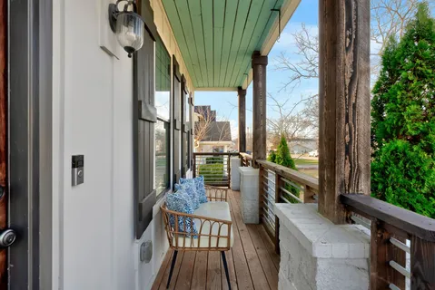 a view of balcony with wooden floor and outdoor seating