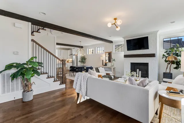 a living room with furniture a flat screen tv and a fireplace