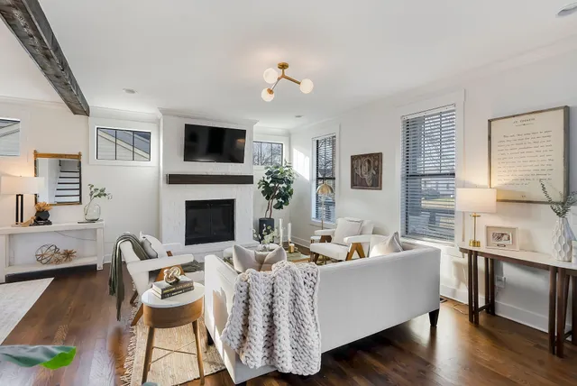 a living room with furniture fireplace and flat screen tv