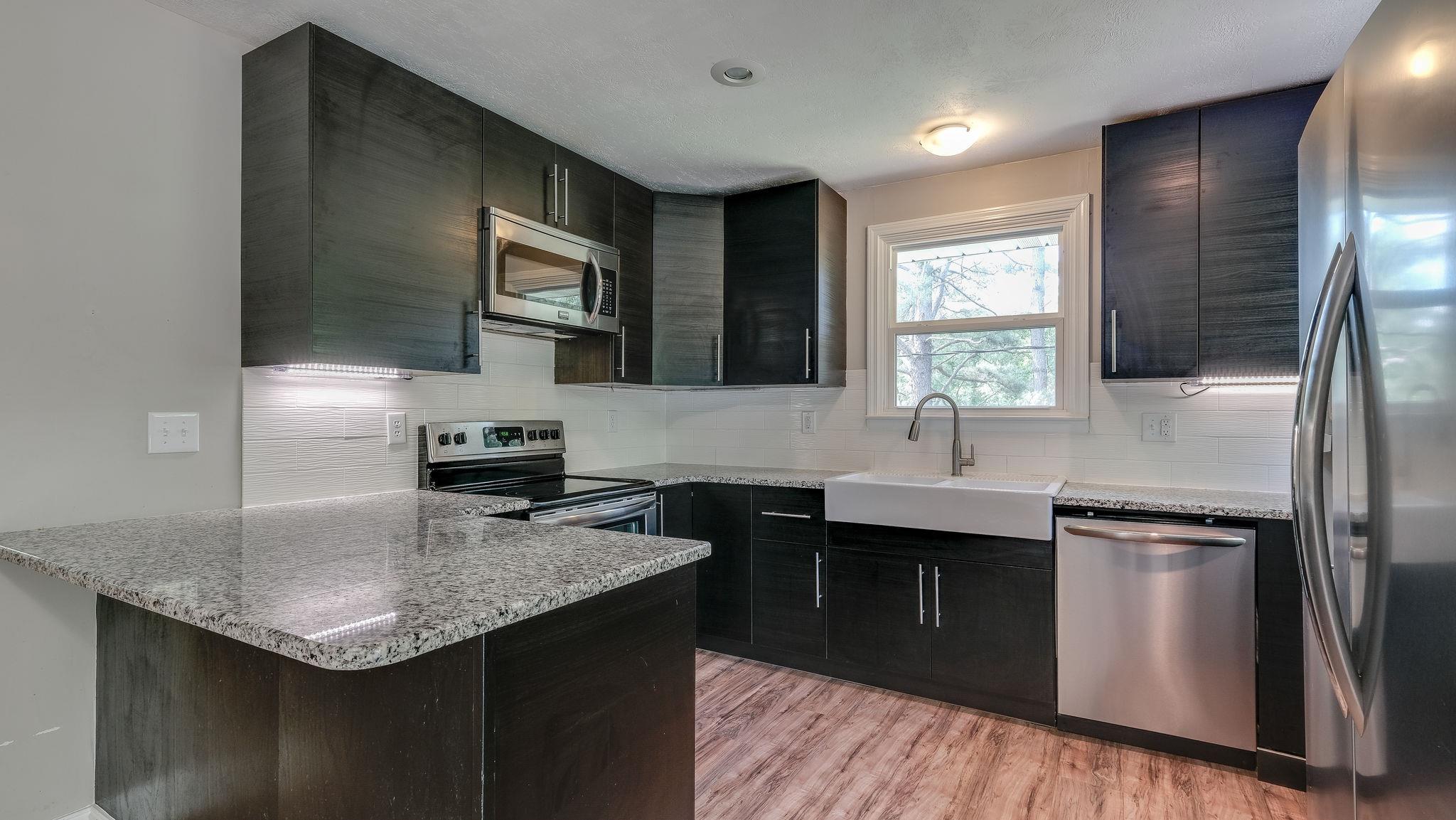 7373 Harper Road Joelton, TN 37080 - Photo 13 of 30 Back in the kitchen, there is modern flair w/Ikea cabinetry, granite counter tops, stainless appliances including built in microwave~
