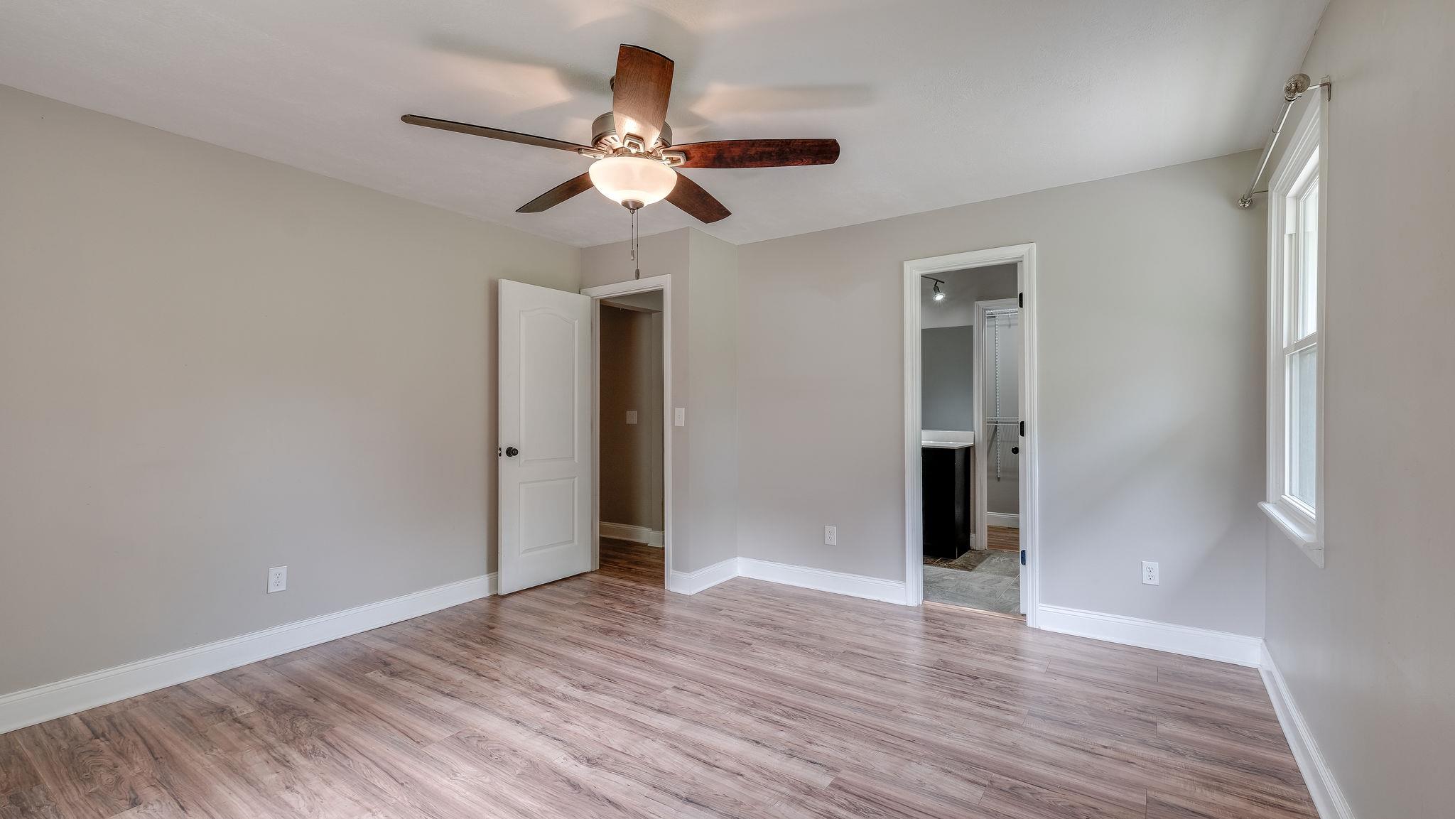 7373 Harper Road Joelton, TN 37080 - Photo 16 of 30 Down the hallway, the master suite is to die for~Large room with en suite bath w/a fresh modern look~Large walk in closet