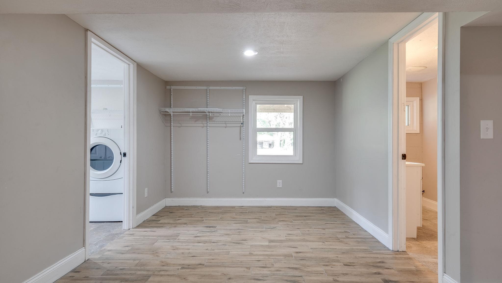 7373 Harper Road Joelton, TN 37080 - Photo 26 of 30 There is more area in the basement that could easily work as a hobby room or studio~The basement is very light filled due to so many windows and doors, and even has a small deck outside for more outdoor living area~