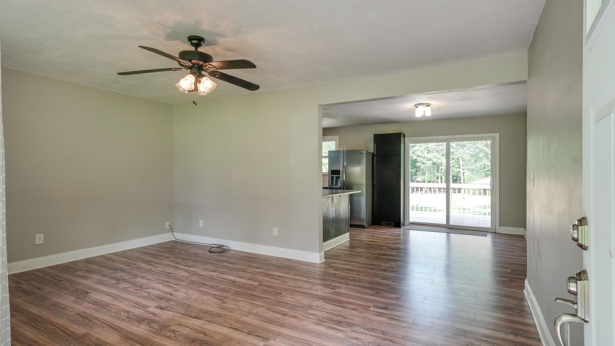 7373 Harper Road Joelton, TN 37080 - Photo 9 of 30 This room has been opened up to an eat in kitchen that is laid out beautifully w/an island for seating, eat in area and large sliding doors that open out onto the deck~