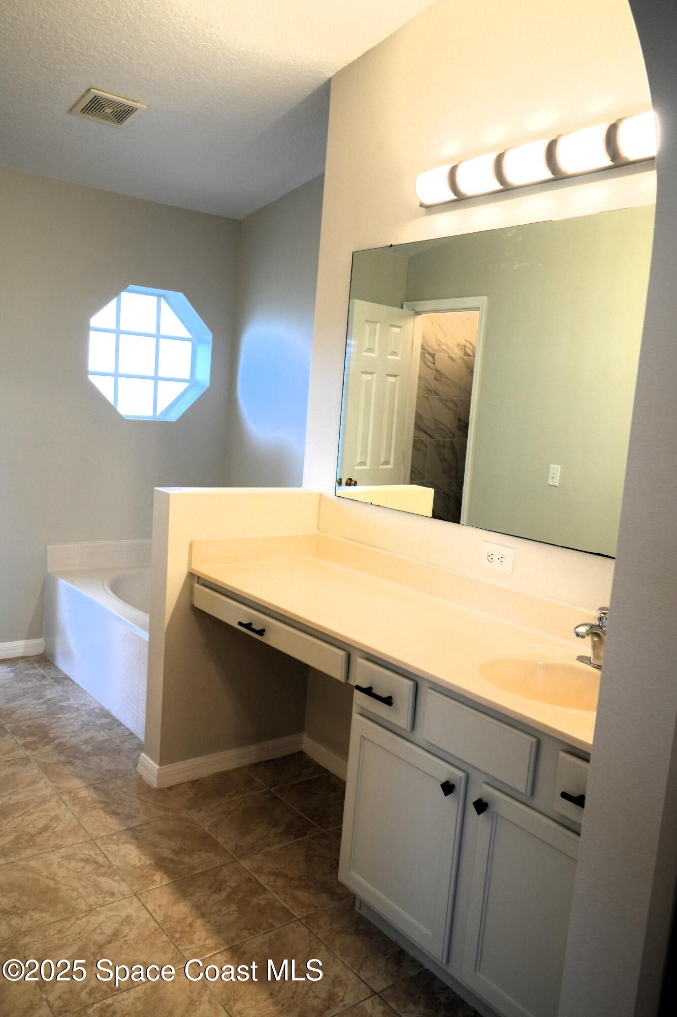 2125 Canopy Drive Melbourne, FL 32935 - Photo 11 of 18 a room with a sink and a mirror