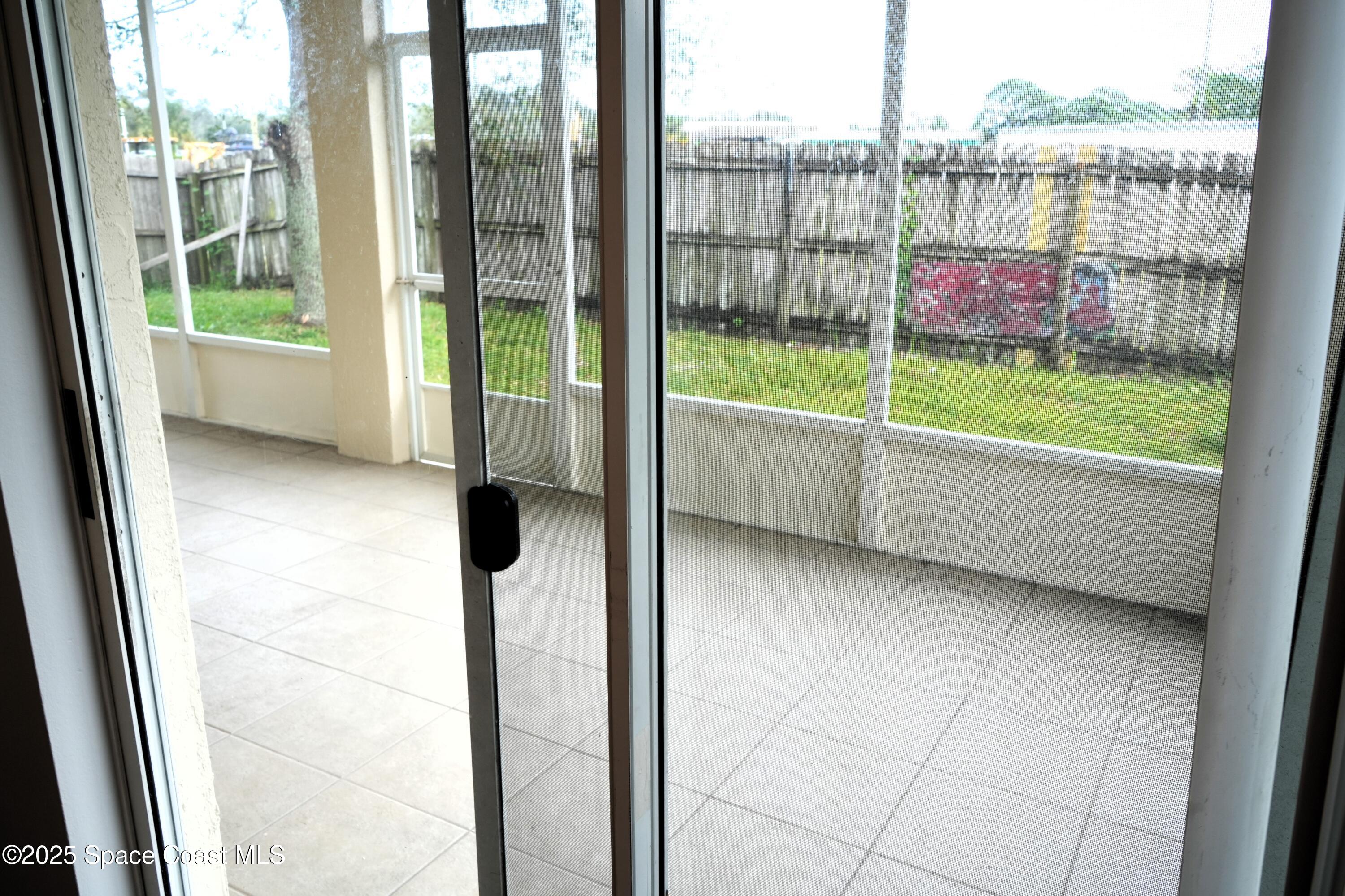 2125 Canopy Drive Melbourne, FL 32935 - Photo 16 of 18 a view of a living room and floor to ceiling window