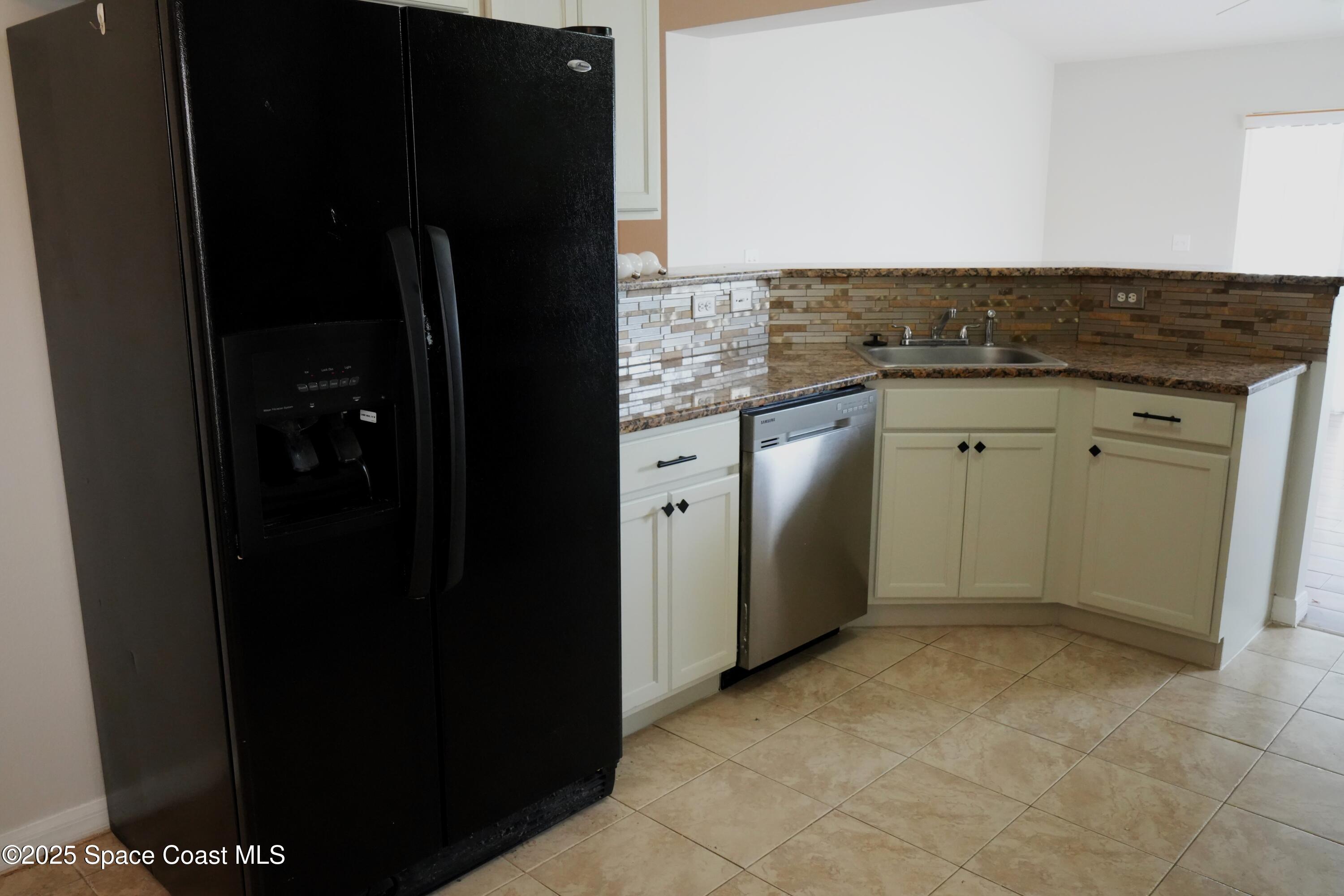 2125 Canopy Drive Melbourne, FL 32935 - Photo 3 of 18 a kitchen with a refrigerator and a stove