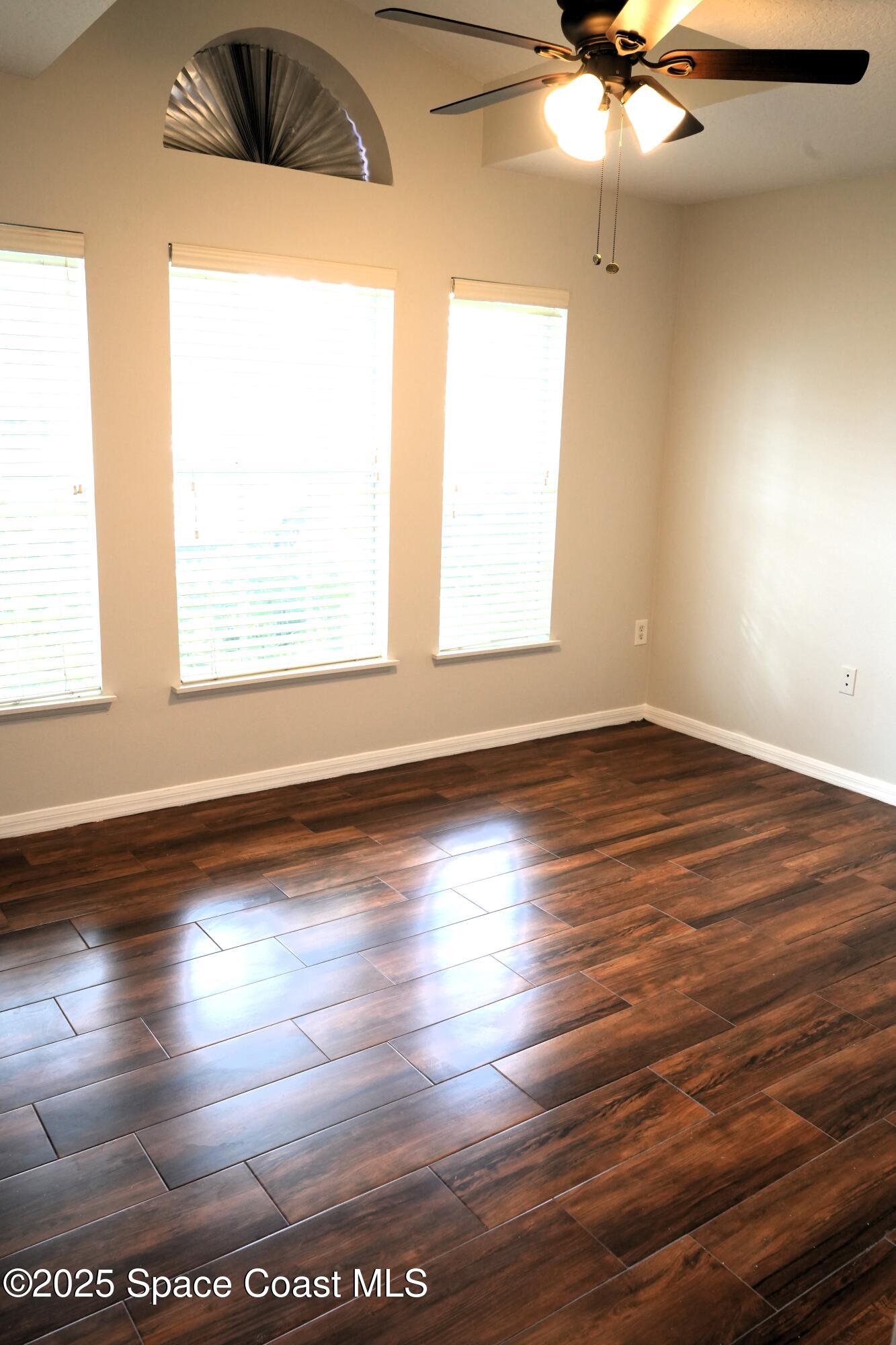 2125 Canopy Drive Melbourne, FL 32935 - Photo 6 of 18 an empty room with wooden floor and windows