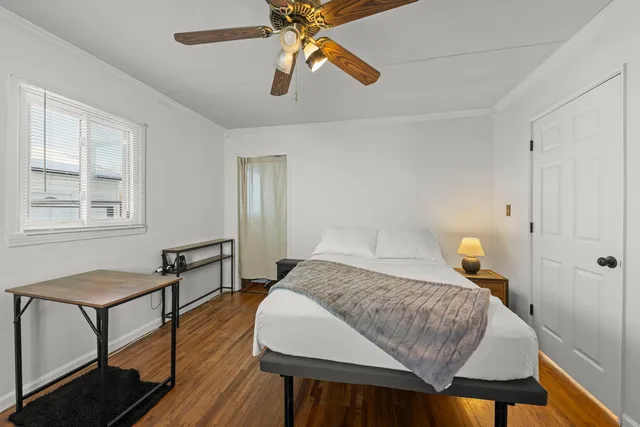 a bedroom with a bed and wooden floor