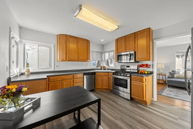 a kitchen with wooden floors and appliances